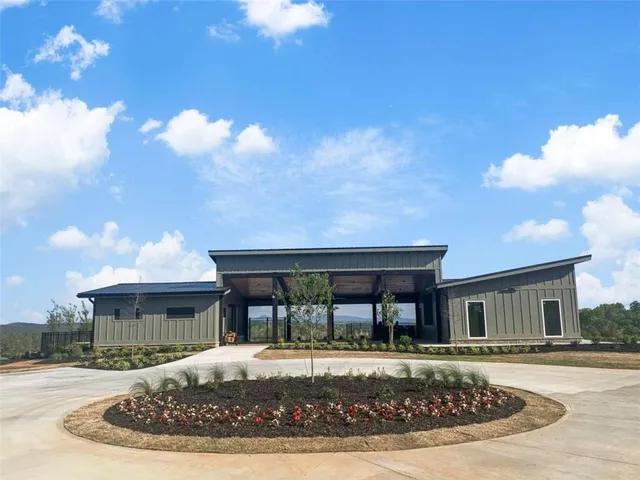 a view of a lake with a floor to ceiling window and a yard