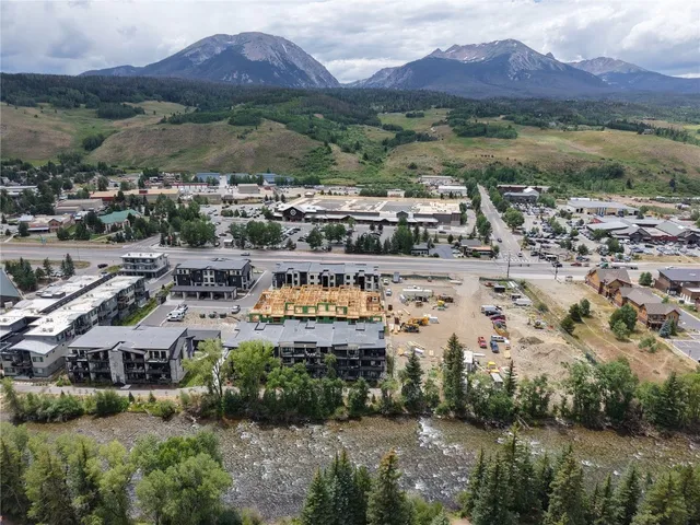 a aerial view of a house with a mountain