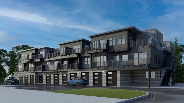 a front view of a building with streets and trees