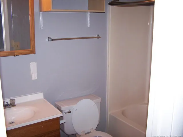 a bathroom with a toilet and a bathtub