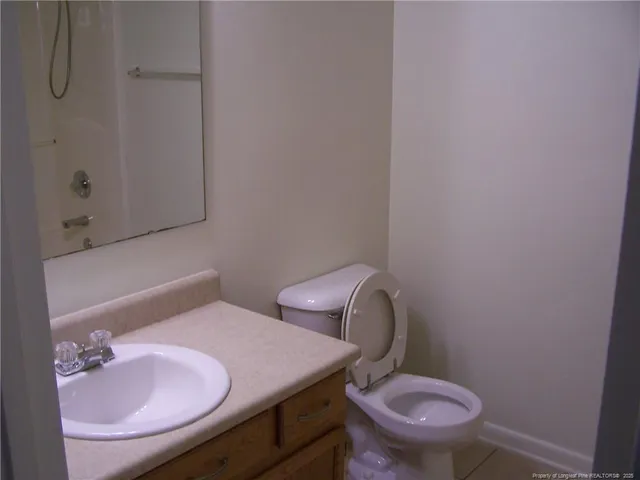 a white toilet sitting next to a bathroom sink