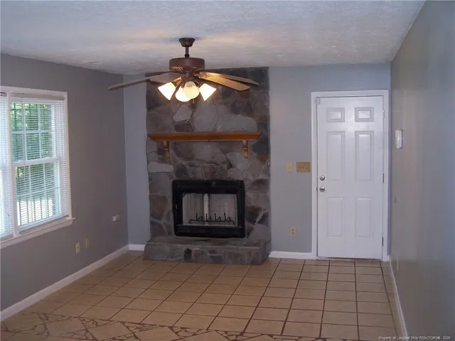 a view of an empty room with a fireplace