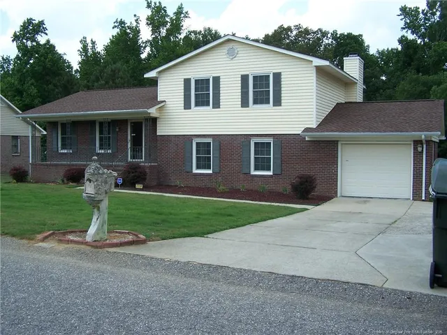 a view of a yard in front view of a house