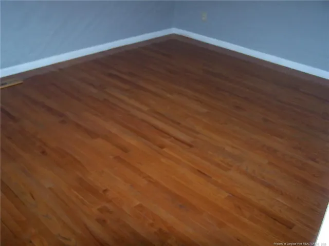 an empty room with wooden floor