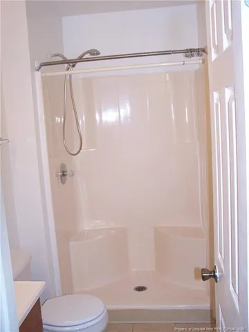 a bathroom with a shower and a toilet