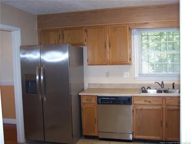 a kitchen with cabinets and window