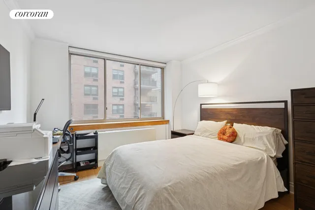 a bedroom with a bed and a large window