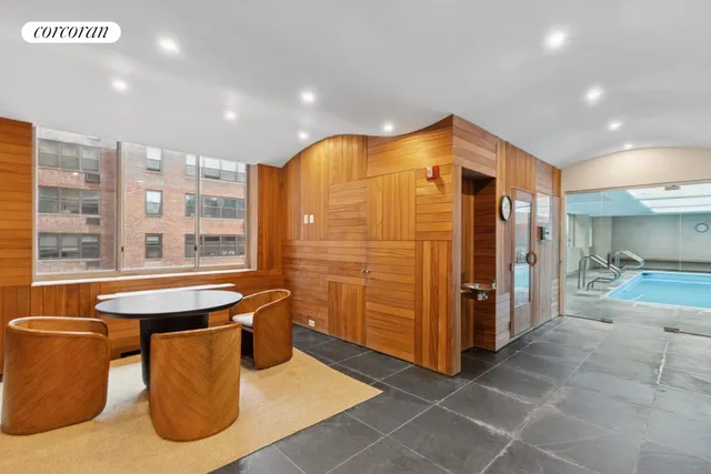 a bathroom with a tub sink shower and mirror