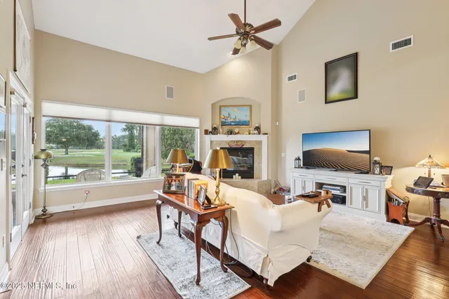 a living room with furniture a fireplace and a flat screen tv