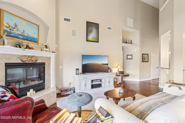 a living room with furniture a flat screen tv and a fireplace
