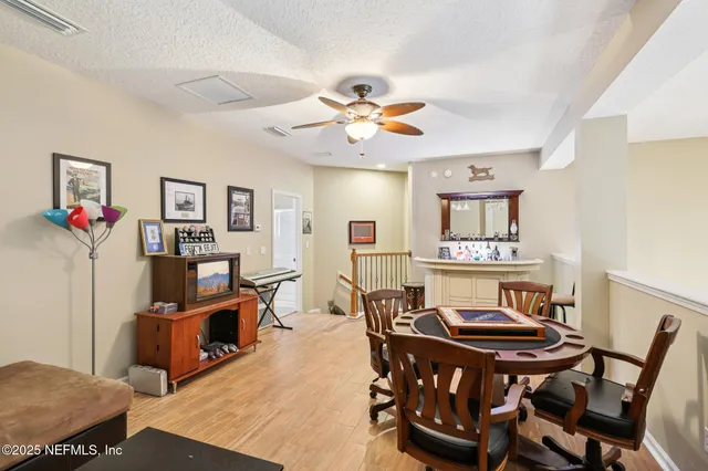 a living room with furniture a window and a flat screen tv
