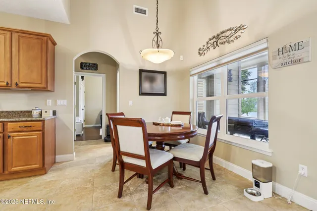 a view of a dining room with furniture and a window