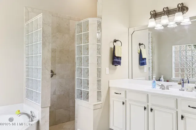 a en suite bathroom with a sink a mirror and a shower
