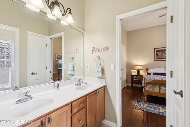 a bathroom with a sink vanity granite and a mirror