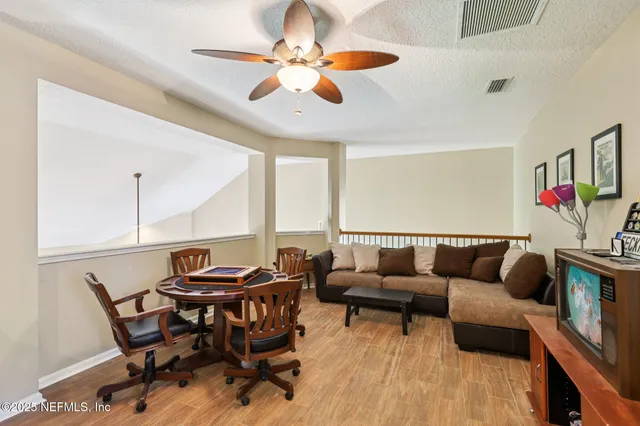 an aerial view of a house with a garden and lake view