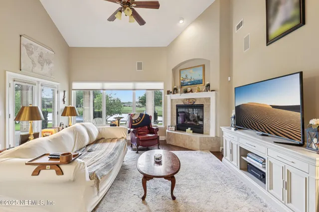 a living room with furniture flat screen tv and a fireplace