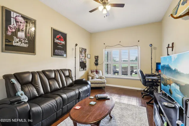 a living room with furniture and a flat screen tv