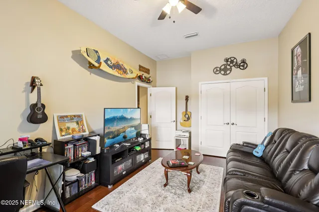 a living room with furniture and a flat screen tv