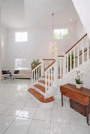 a living room with couches a dining table and chairs with outer view