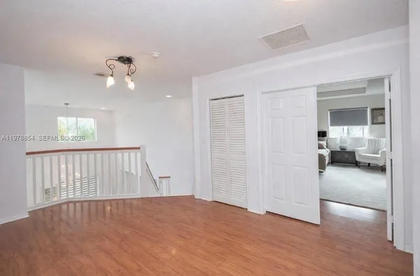 a view of empty room and wooden floor