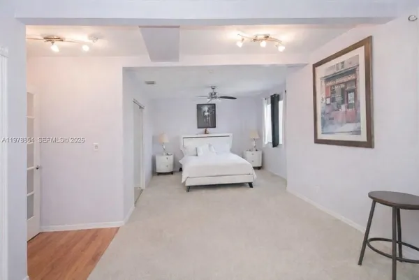 a en suite spacious bedroom with a bed and furniture