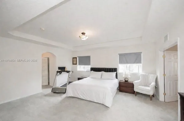 a bedroom with bed and a couch