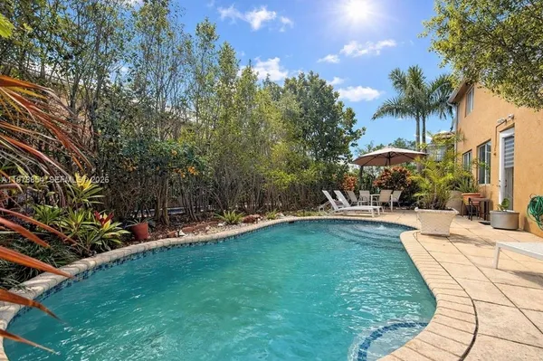 a swimming pool with outdoor seating and yard