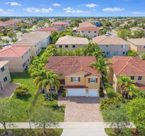 an aerial view of a houses with a lake view