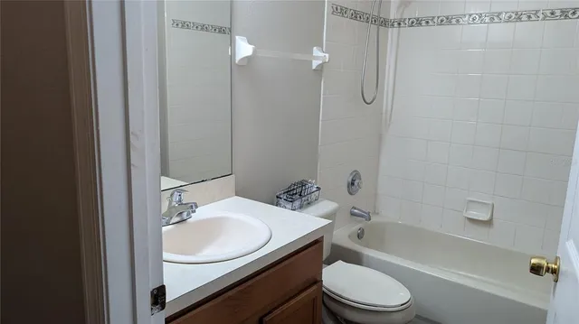 a view of a hallway with wooden floor and a window