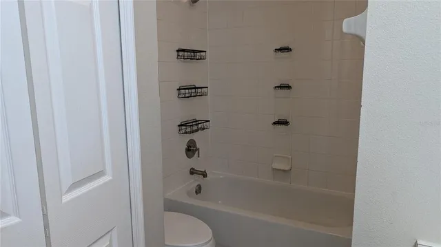 a view of a hallway with wooden floor and a window