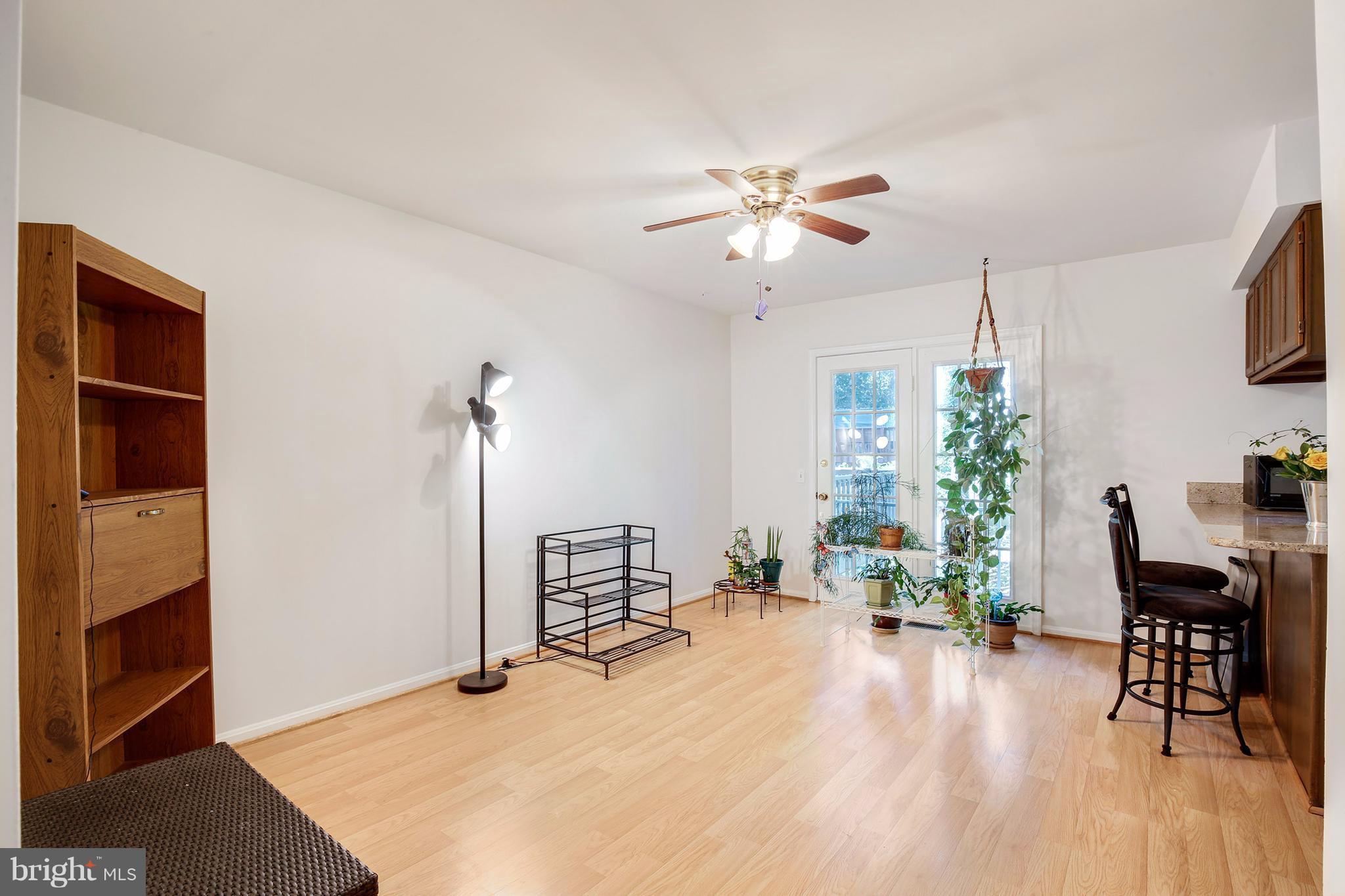 301 Crescendo Way Silver Spring, MD 20901 - Photo 12 of 30 a living room with furniture and wooden floor