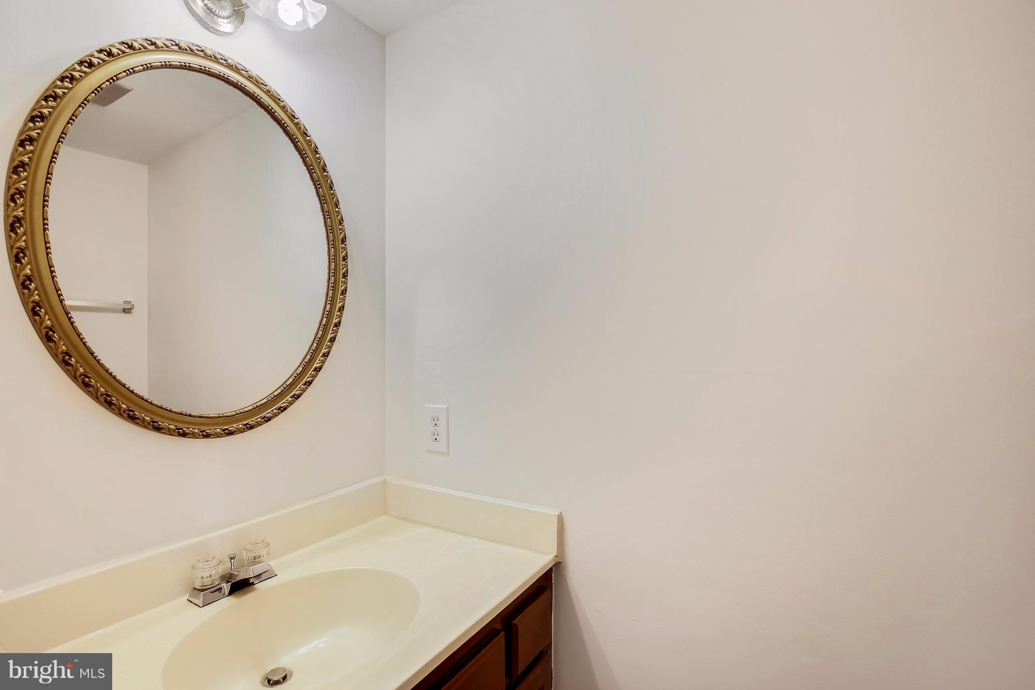 301 Crescendo Way Silver Spring, MD 20901 - Photo 18 of 30 a bathroom with a sink and a mirror