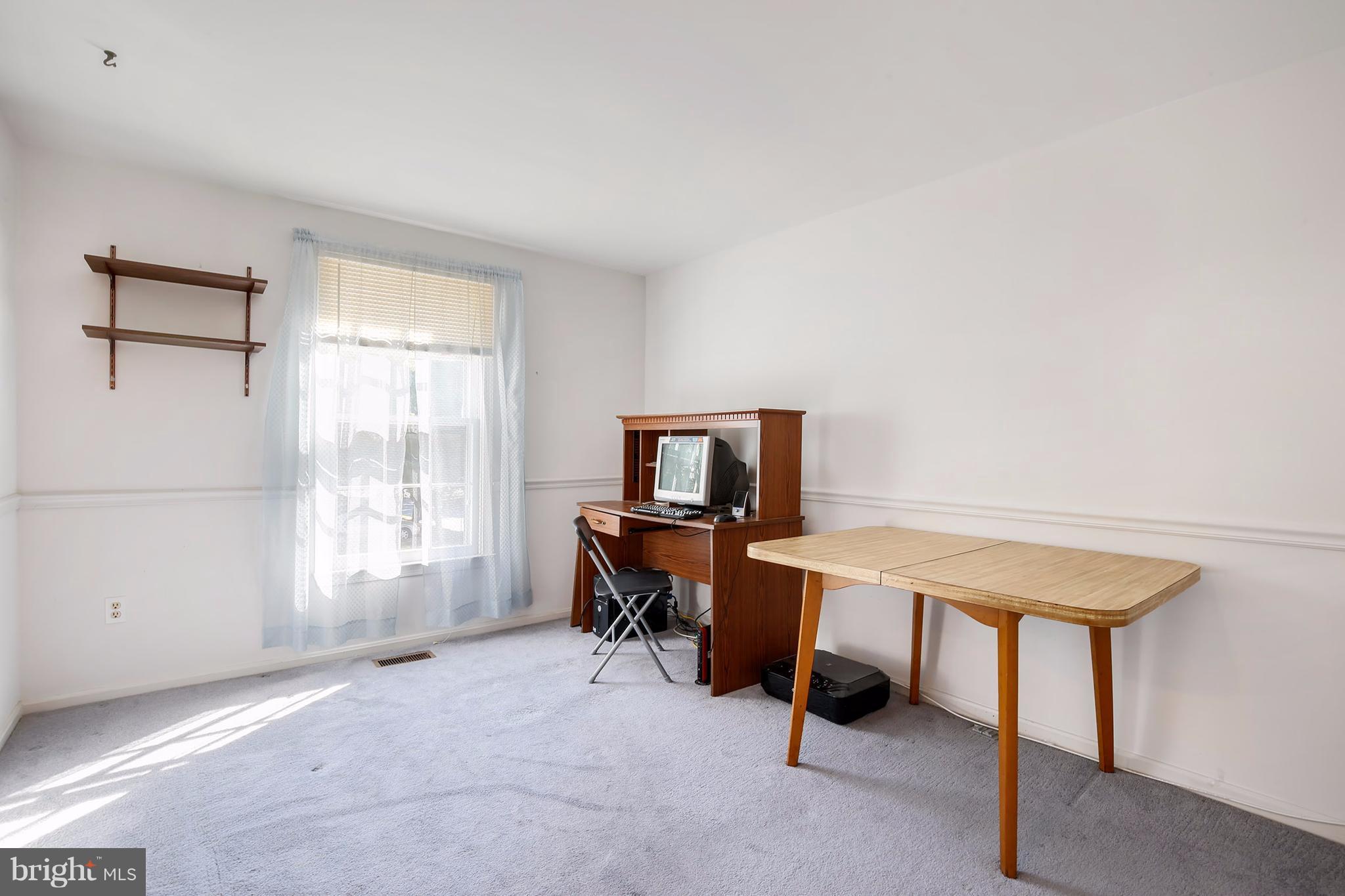 301 Crescendo Way Silver Spring, MD 20901 - Photo 19 of 30 a view of a workspace with furniture and a window