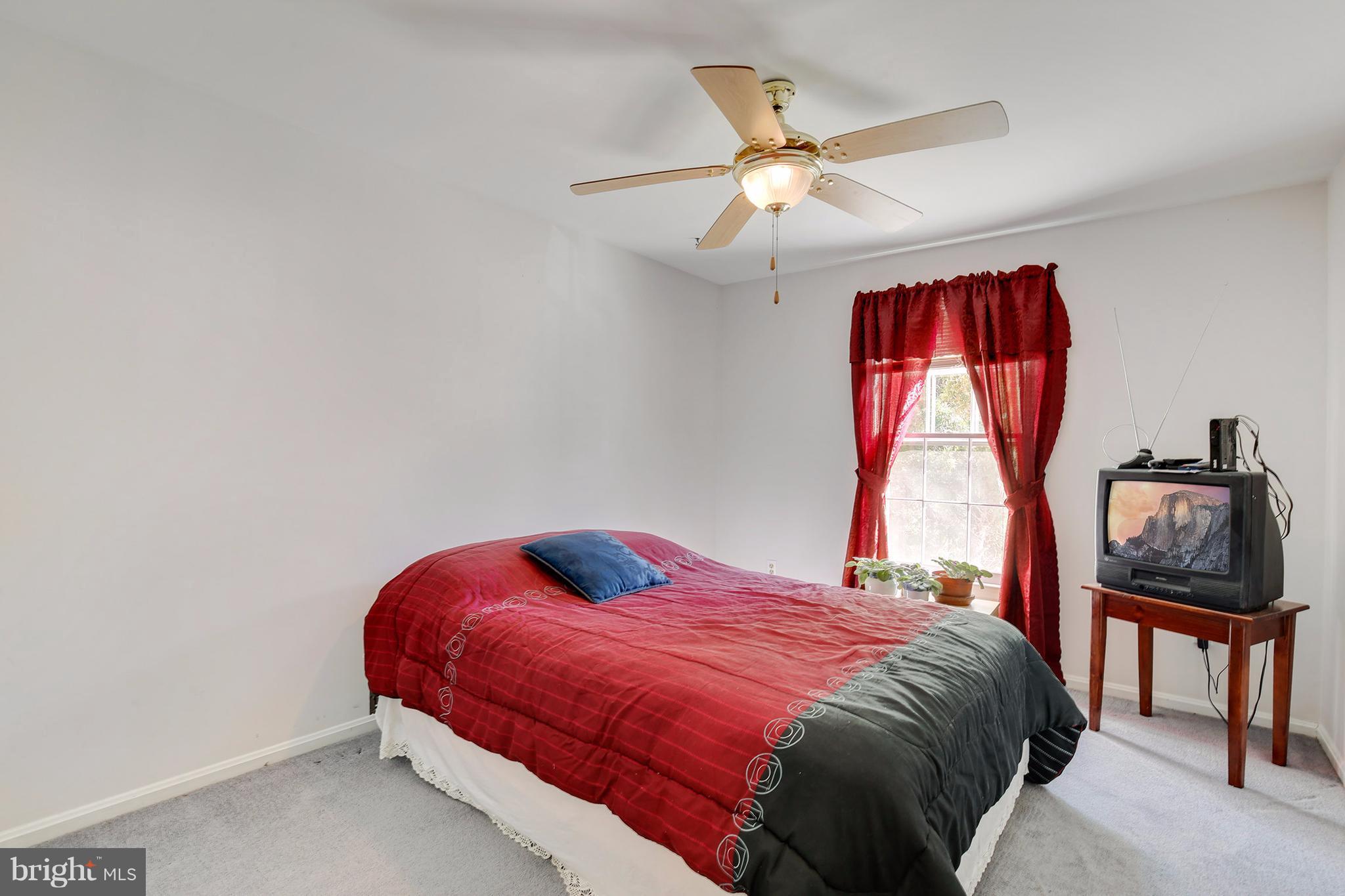 301 Crescendo Way Silver Spring, MD 20901 - Photo 21 of 30 a bedroom with a bed and a window