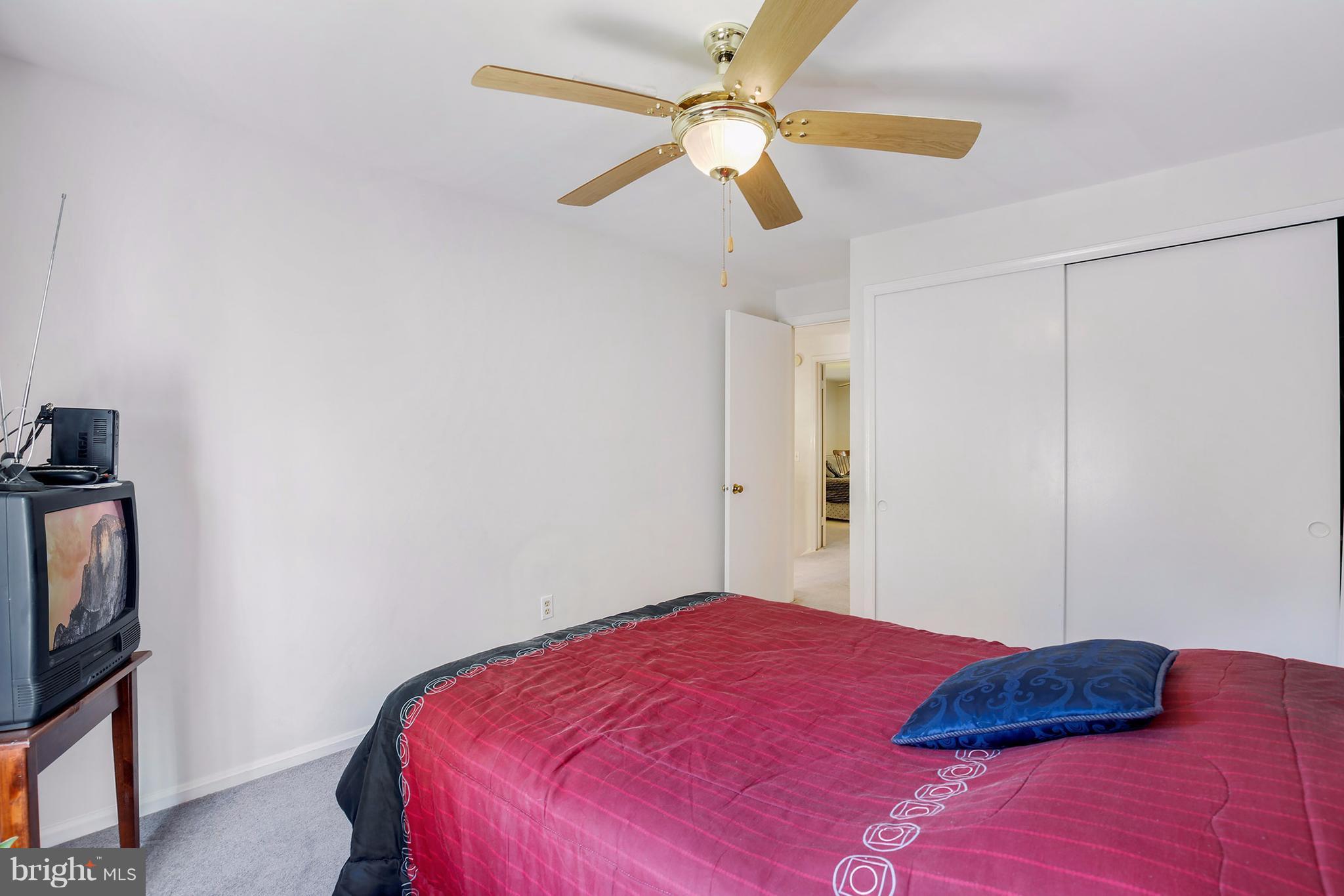 301 Crescendo Way Silver Spring, MD 20901 - Photo 22 of 30 a bedroom with a bed and a television