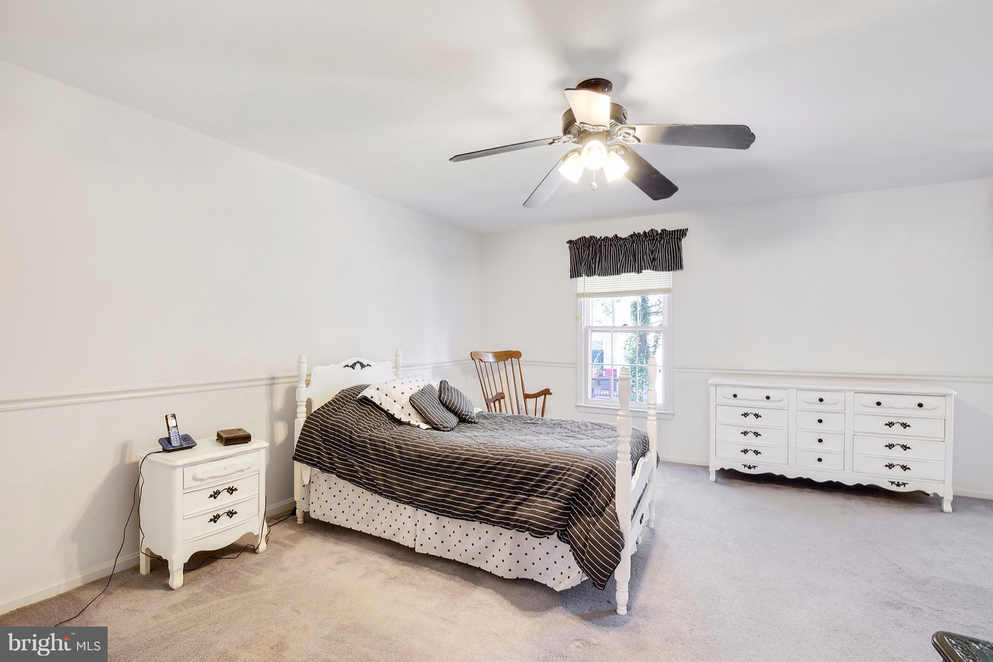 301 Crescendo Way Silver Spring, MD 20901 - Photo 24 of 30 a bedroom with a bed and a ceiling fan