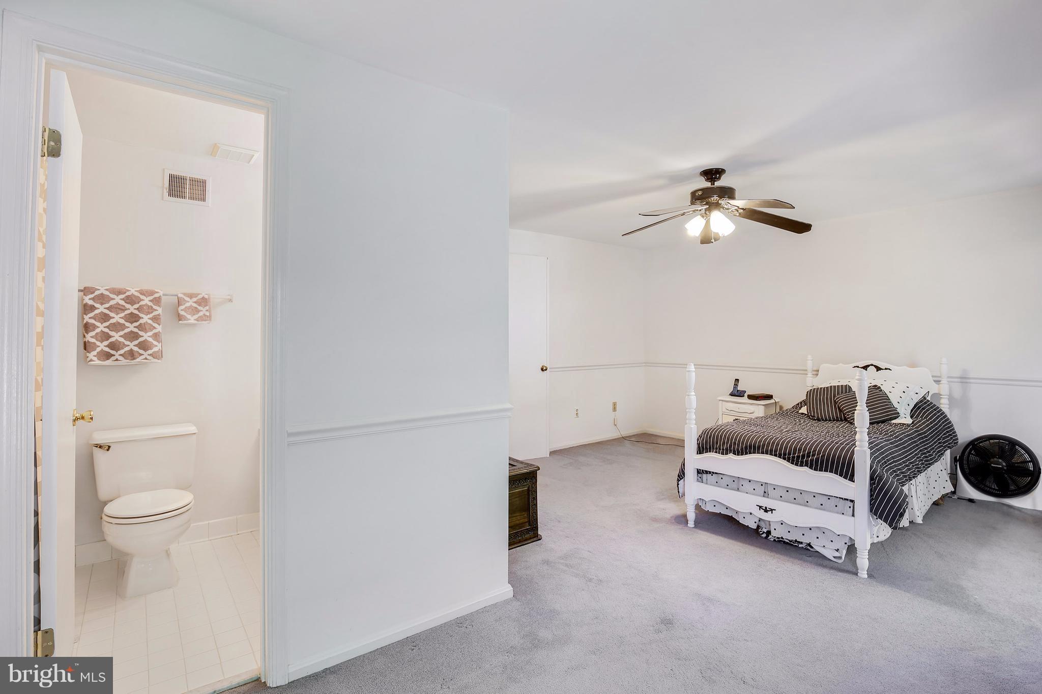 301 Crescendo Way Silver Spring, MD 20901 - Photo 26 of 30 a bedroom with a bed and a chandelier