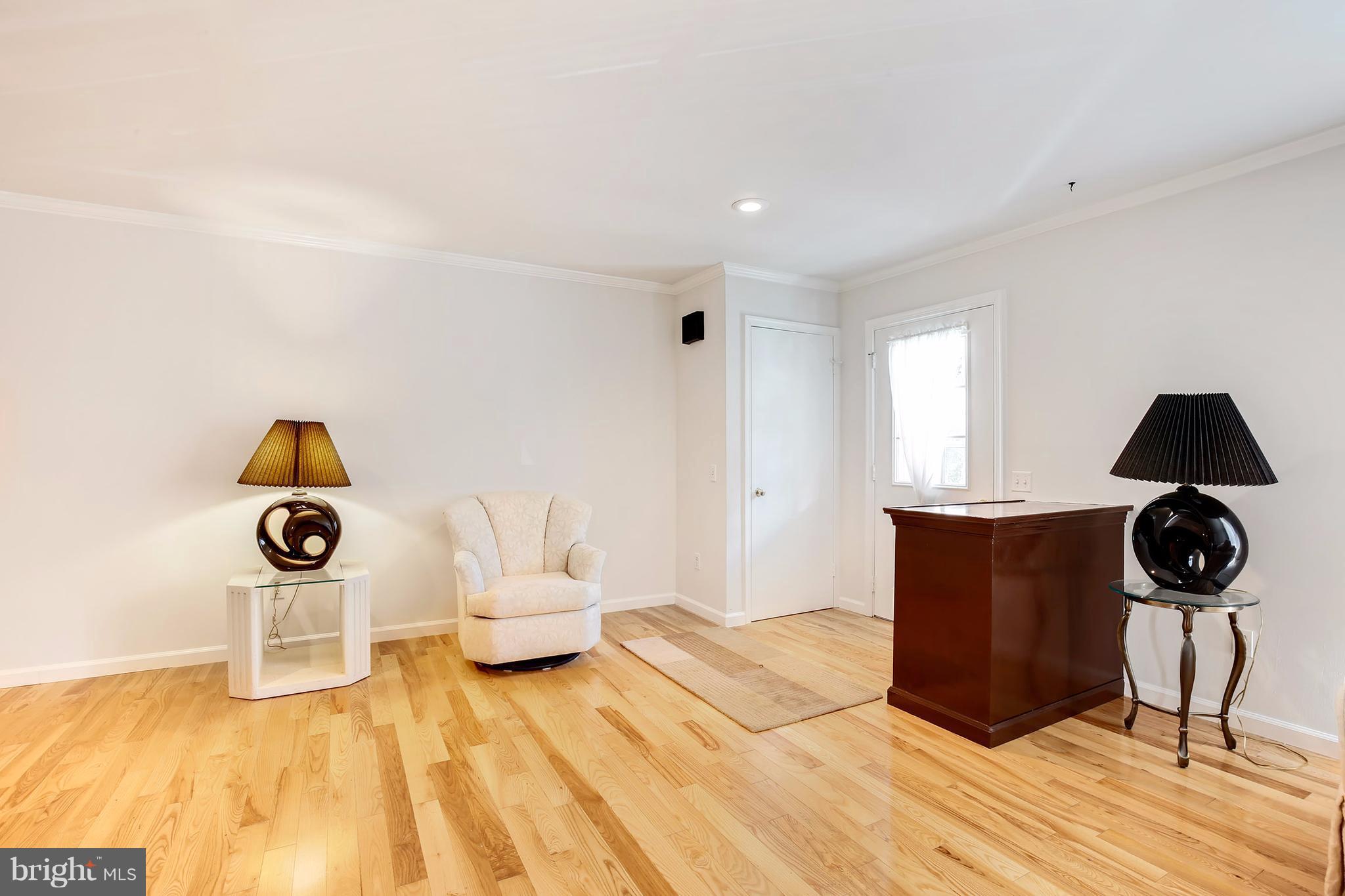 301 Crescendo Way Silver Spring, MD 20901 - Photo 8 of 30 a bedroom with a bed and wooden floor