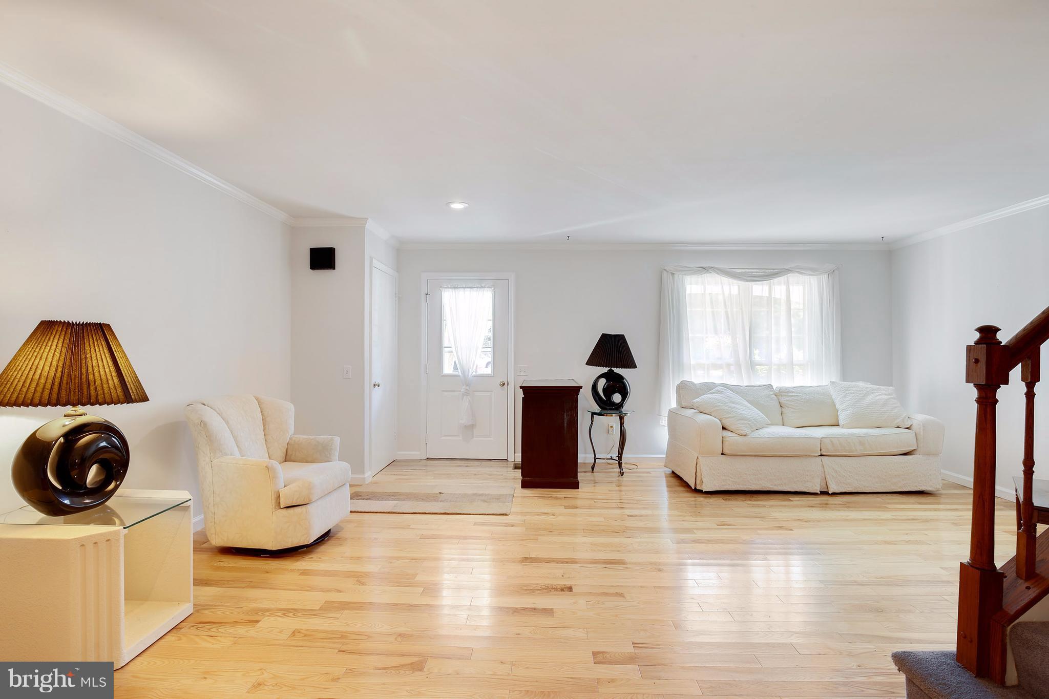 301 Crescendo Way Silver Spring, MD 20901 - Photo 10 of 30 a living room with furniture and a flat screen tv