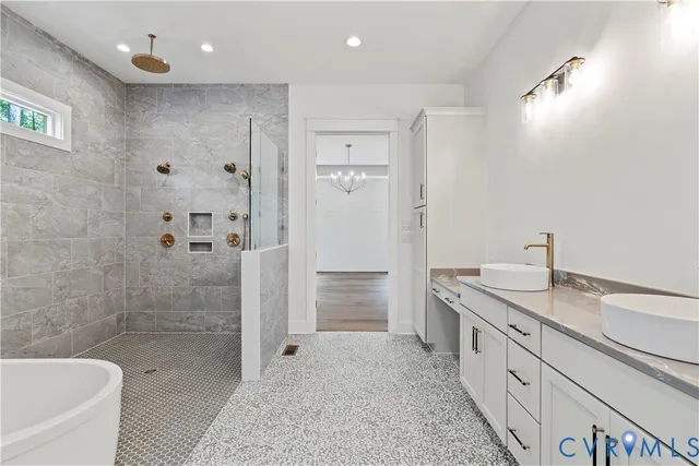 a bathroom with a granite countertop sink mirror bathtub and shower