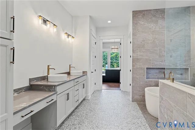 a large white kitchen with a sink and a large mirror