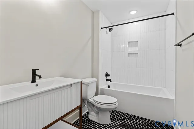 a bathroom with a toilet a sink and a shower