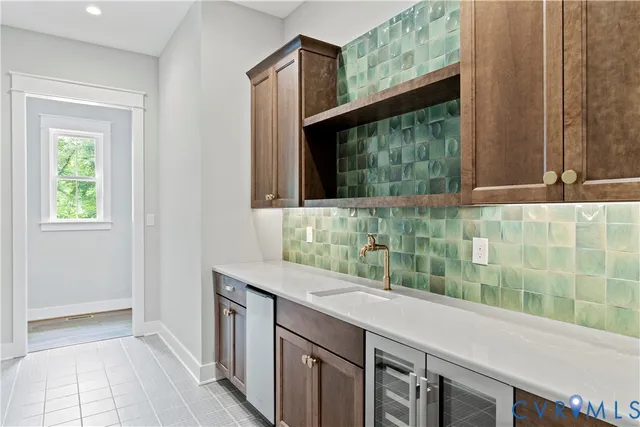 a bathroom with a granite countertop sink and a window