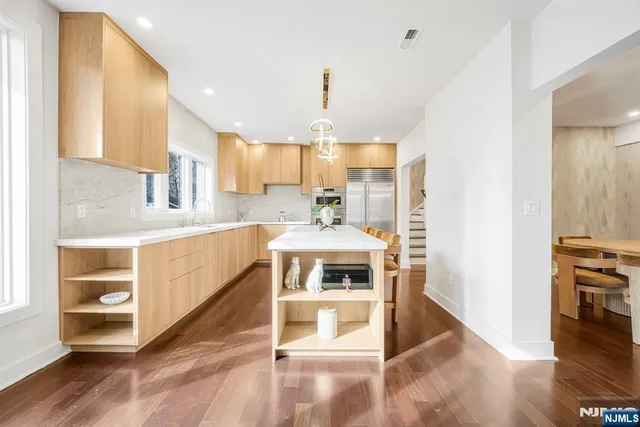 a kitchen with kitchen island a stove a sink and a refrigerator