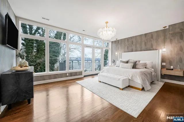 a spacious bedroom with a bed and glass window