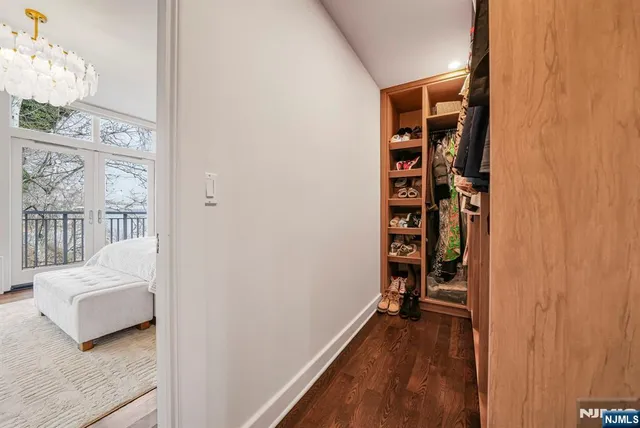 a view of a bedroom with wooden floor and furniture