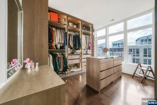 a living room with furniture fireplace and wooden floor