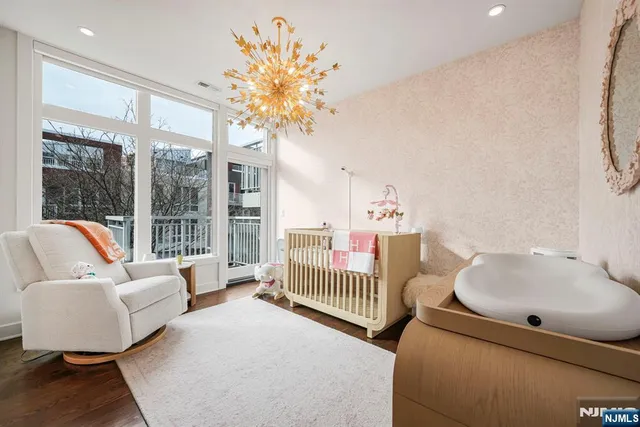 a bedroom with furniture and a large window