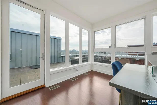 a view of a livingroom with furniture and floor to ceiling window