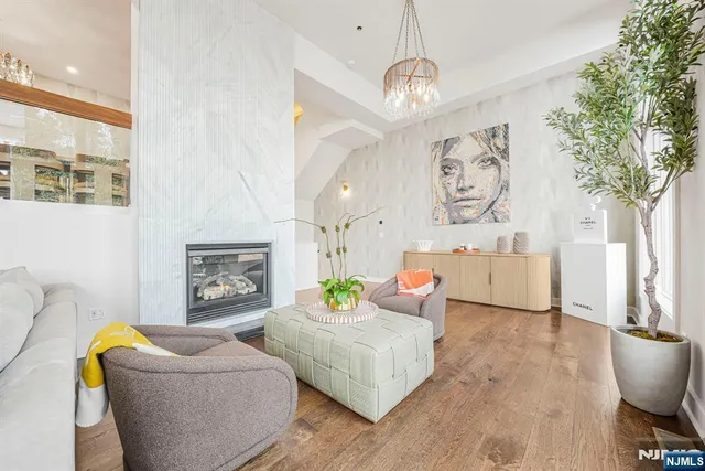 a living room with furniture and a chandelier